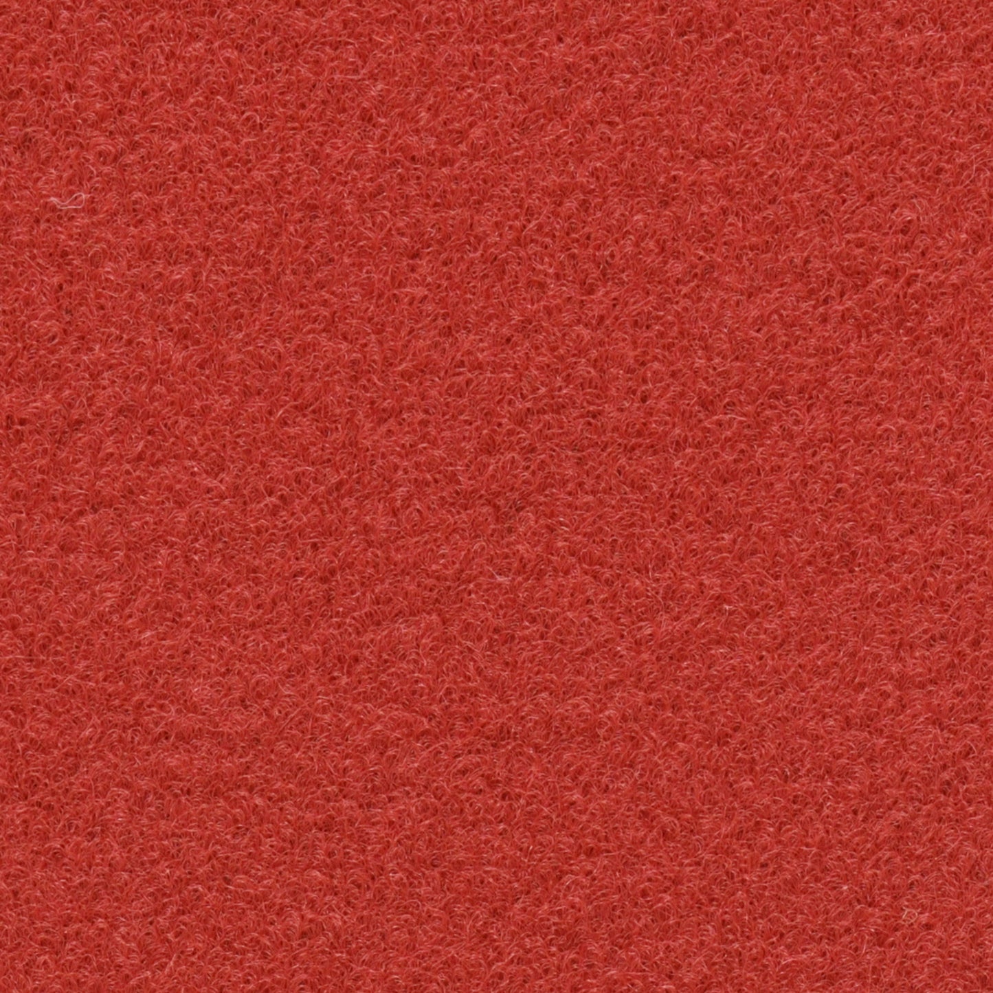 Roter Teppichboden zeigt eine dichte, faserige Textur ohne sichtbare Muster oder Objekte.