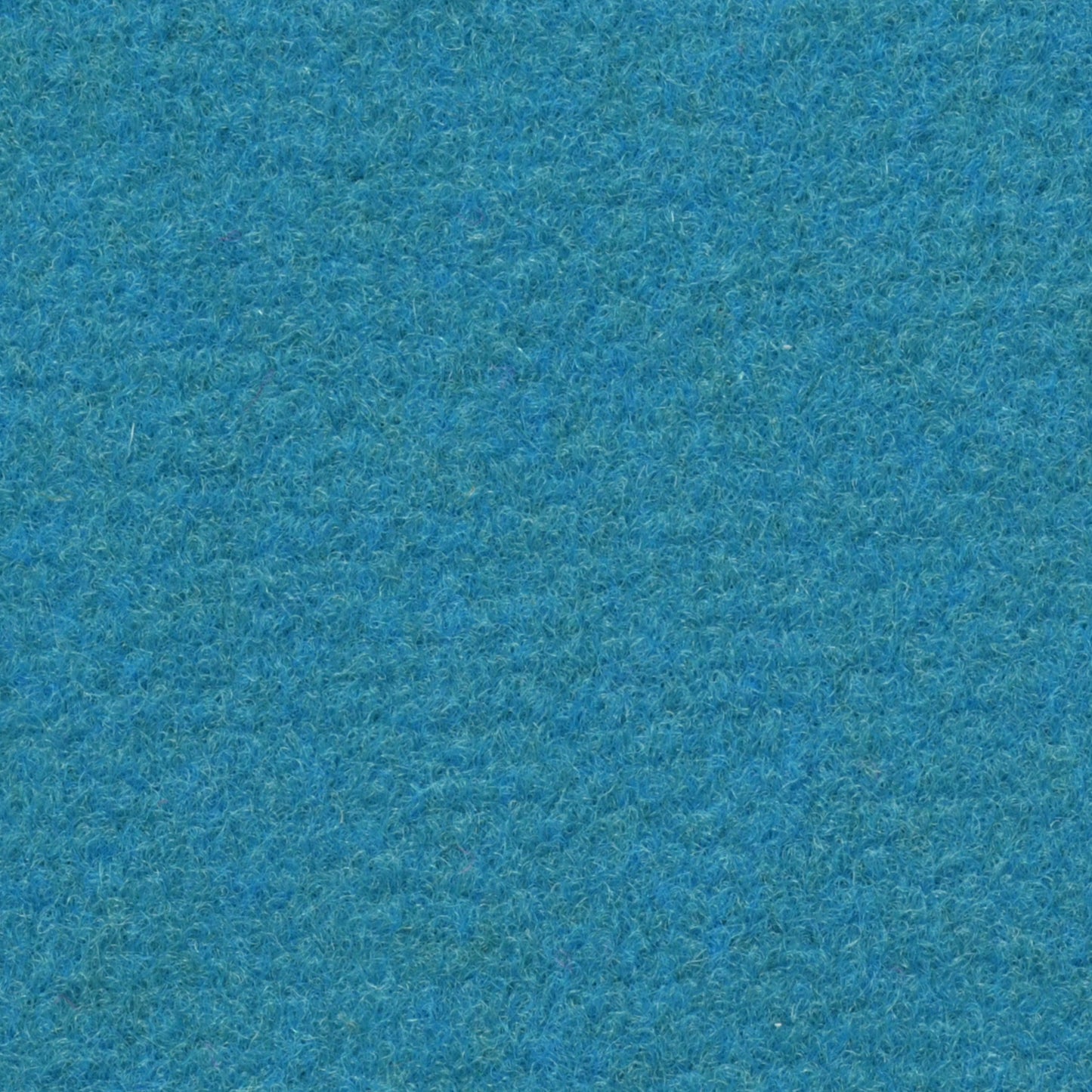 Blaue, texturierte Oberfläche mit dichter, flauschiger Struktur, die an weichen Filz erinnert. Sie wirkt beruhigend und gleichmässig.