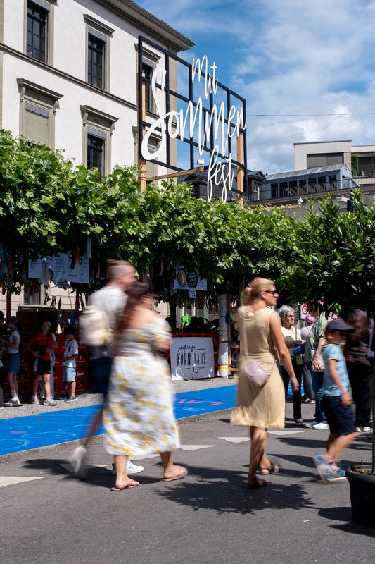 Mitsommerfest in Frauenfeld, ein blauer Teppich liegt auf dem Boden, vor laufen Personen entlang.